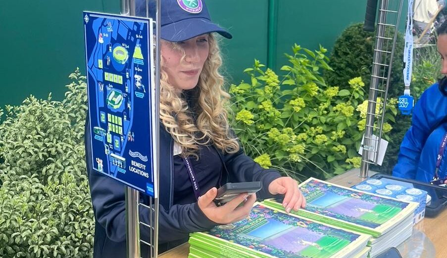 Image of someone selling the Wimbledon programmes that were designed and published by PPL Group